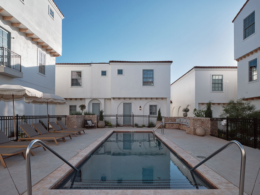 a building with a pool and a pool table in front of it