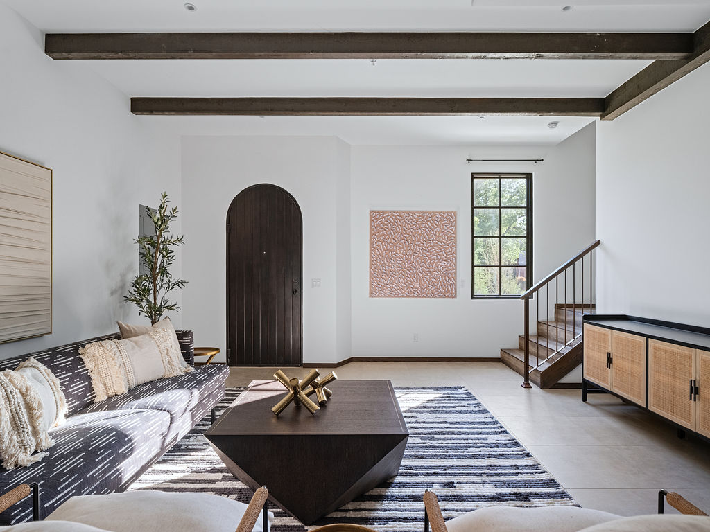 a living room filled with furniture and a large window