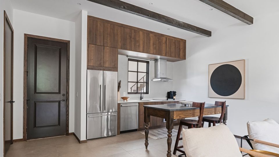 a kitchen with a table and chairs and a refrigerator
