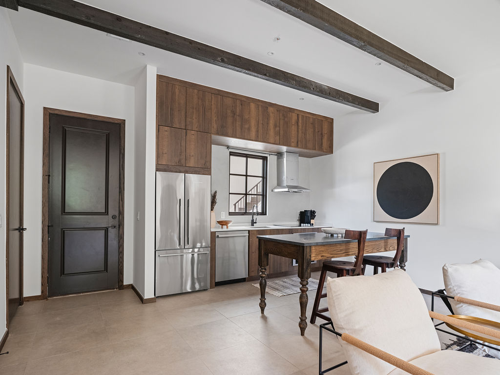 a kitchen with a table and chairs and a refrigerator