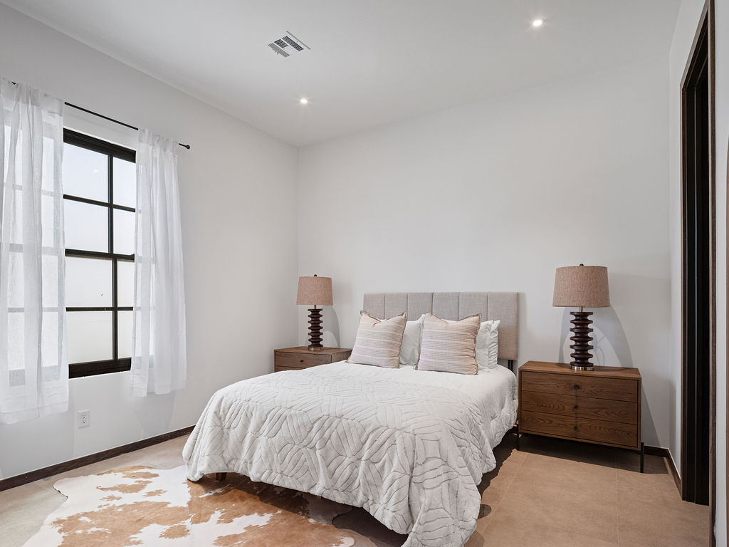 a bedroom with a white bed and white walls