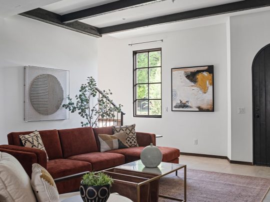 a living room filled with furniture and a window