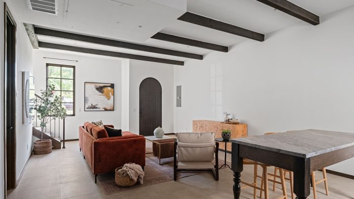 a living room filled with furniture and a large window