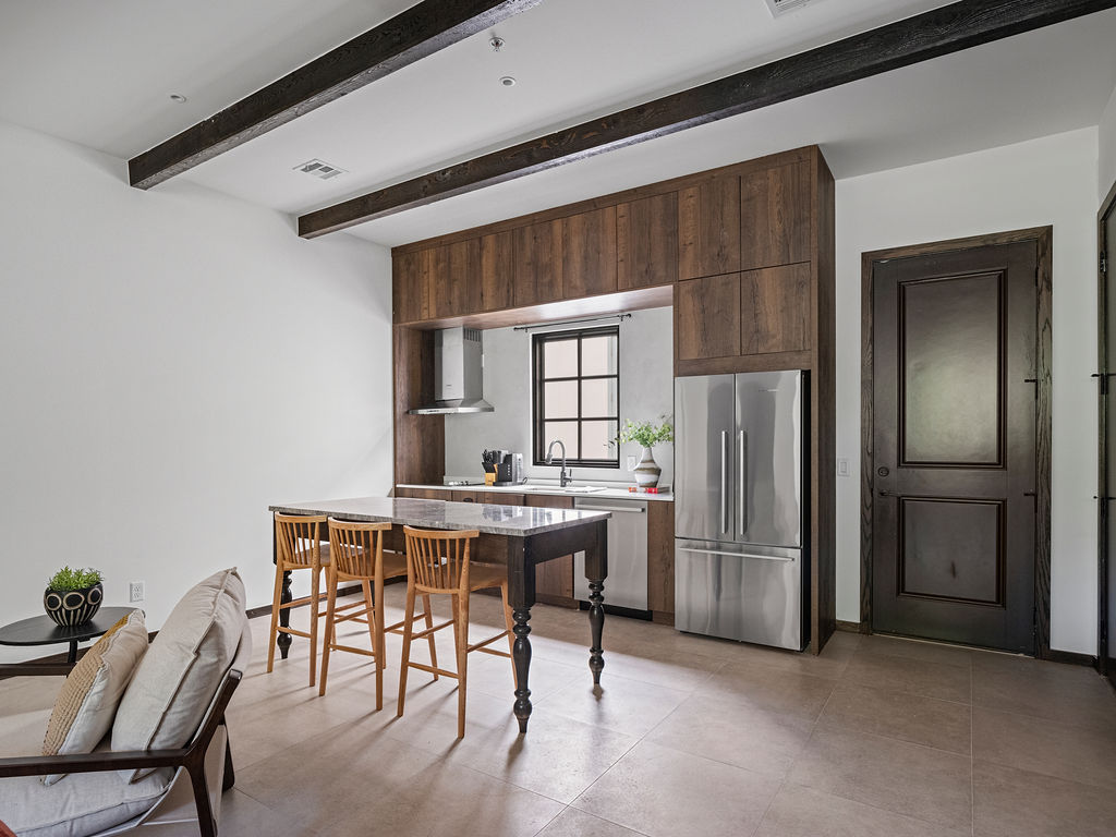 a kitchen with a table and chairs and a refrigerator