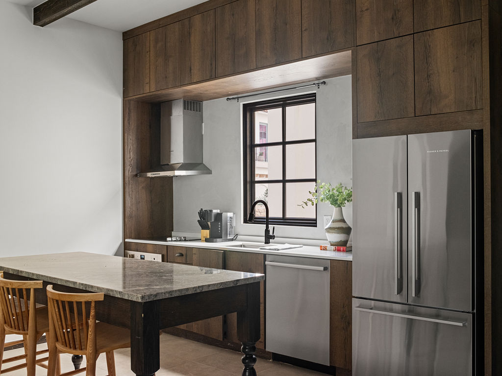 a kitchen with a refrigerator, stove, sink and dishwasher