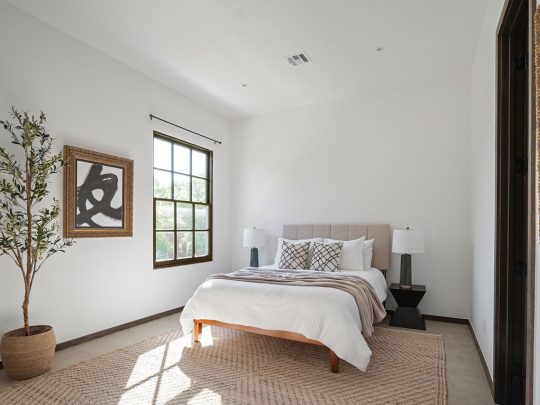 a bedroom with a large bed and a large window