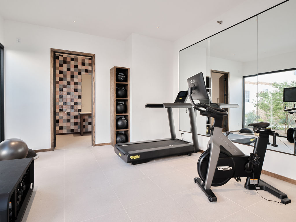 a living room with a chair and a tv