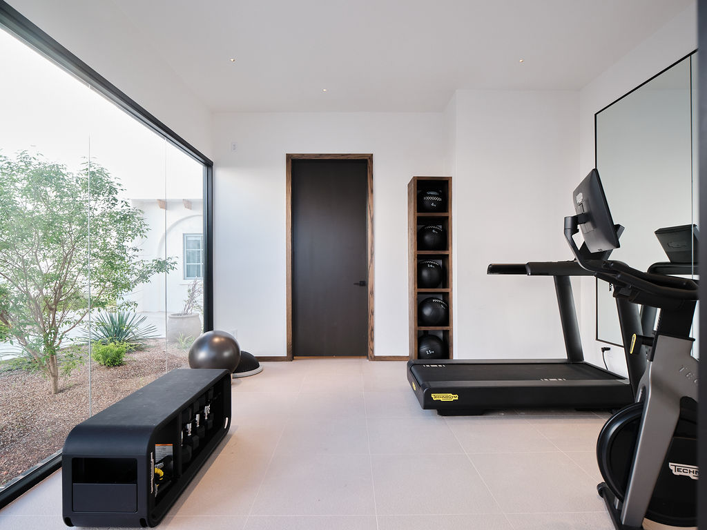 a living room filled with furniture and a large window