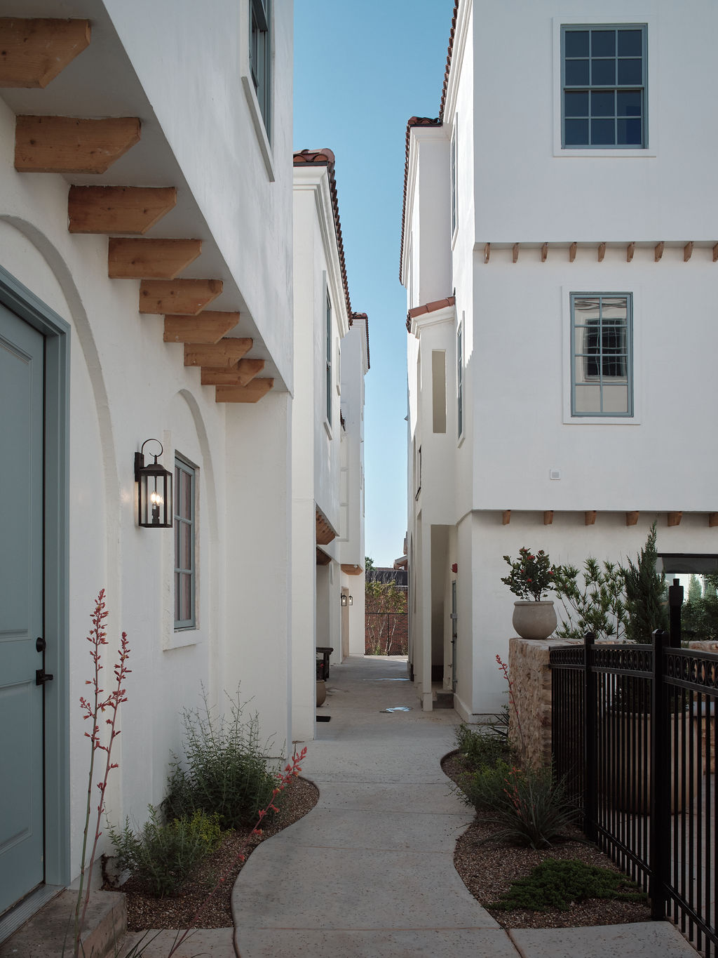 a narrow alleyway leads to a small house